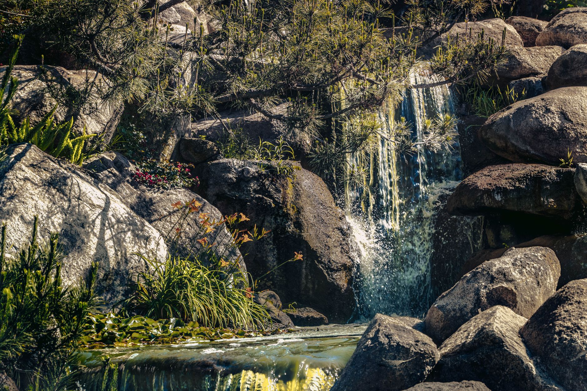 A small waterfall among rocks and greenery